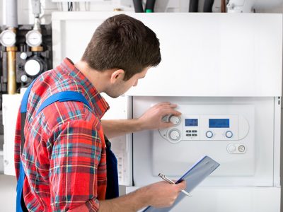 Technician servicing the gas boiler for hot water and heating
